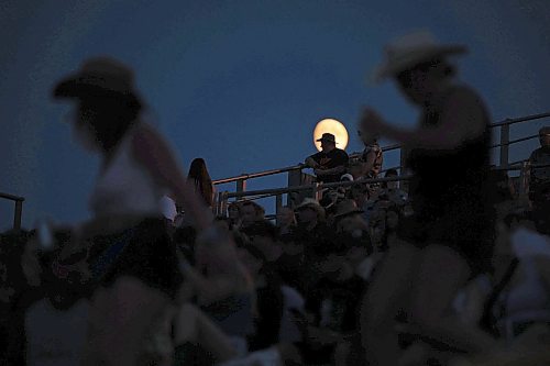 30062023
The moon rises behind country music fans watching Walker Hayes perform on the main stage at Dauphin&#x2019;s Countryfest 2023 on Friday evening.
(Tim Smith/The Brandon Sun)

