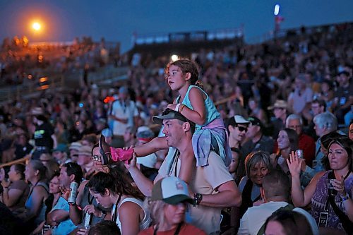 30062023
Mike Lee holds his niece Brooklyn Pernarowski on his shoulders while watching Walker Hayes perform on the main stage at Dauphin&#x2019;s Countryfest 2023 on Friday evening.
(Tim Smith/The Brandon Sun)
