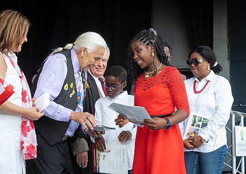 JESSICA LEE / WINNIPEG FREE PRESS

New Canadian citizen Oluwadamilola Adefusi (in red) is welcomed by Elder Dr. Winston Wuttunee (in purple) and Premier Heather Stefanson at a citizenship ceremony July 1, 2023 at Assiniboine Park.

Reporter: Cierra Bettens