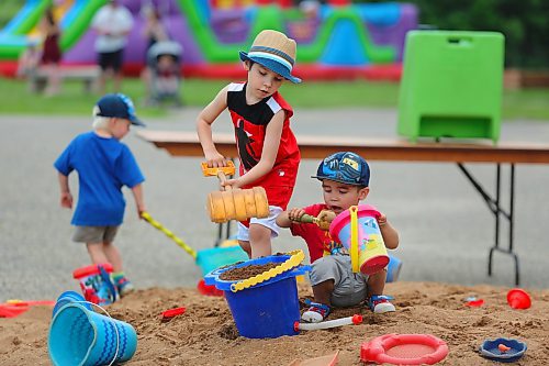 Weston Bailey and Emmett Miller spent part of Canada Day playing at a sandbox that was set up in the Riverbank Discovery Centre parking lot. (Kyle Darbyson/The Brandon Sun)