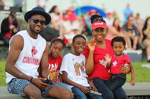 Muyiwa Faronbi, far left, and his family celebrate Canada Day by attending the Fusion Credit Union Stage to watch Full Flannel Jacket perform. (Kyle Darbyson/The Brandon Sun)
