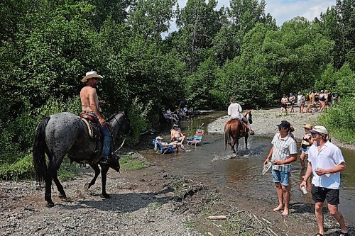 Festival-goers party at the creek near the campground at Dauphin’s Countryfest 2023 on a hot Friday afternoon.
(Tim Smith/The Brandon Sun)
