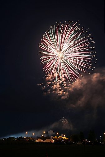A fireball of green, red and white lights up the sky over the Riverbank Discovery Centre on Saturday night, as fireworks mark the end to Canada Day 2023. (Matt Goerzen/The Brandon Sun)
