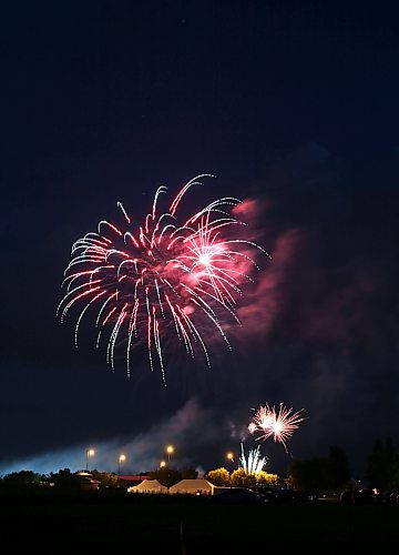 A red fireball explodes in the sky above the Riverbank Discovery Centre in Brandon, as the city marked the end of Canada Day 2023 with a grand display of fireworks. (Matt Goerzen/The Brandon Sun)