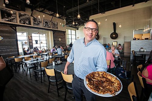 MIKAELA MACKENZIE / WINNIPEG FREE PRESS


Terry Friesen, general manager, holds a Giant Apple Pancake at the Original Pancake House on McGillivray on Thursday, June 29, 2023.   For Dave Sanderson story.
Winnipeg Free Press 2023