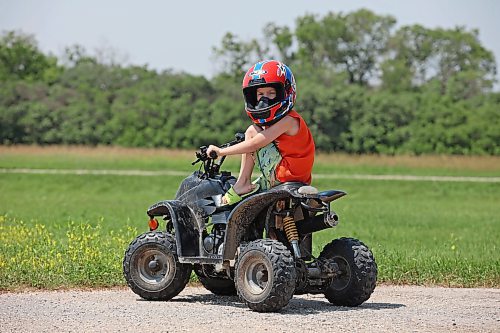 03072023
Five-year-old Ryatt Betts sits atop a mini quad while cruising around a family property west of Brandon on Monday.
(Tim Smith/The Brandon Sun)