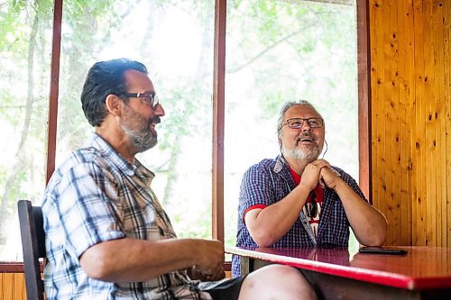 MIKAELA MACKENZIE / WINNIPEG FREE PRESS

Kerry Seabrook (left) and Art Zuke chat with the Free Press in the cabin front porch in Sandy Hook on Monday, July 3, 2023. For Jen story.
Winnipeg Free Press 2023.