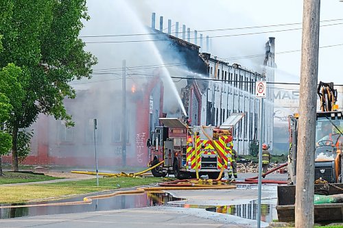 MIKE DEAL / WINNIPEG FREE PRESS
WFPS crews try to douse a large fire in the block on the southwest corner of Sutherland Avenue and Maple Street North Tuesday morning. 
230704 - Tuesday, July 4, 2023. 