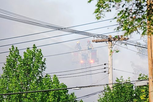 MIKE DEAL / WINNIPEG FREE PRESS
WFPS crews try to douse a large fire in the block on the southwest corner of Sutherland Avenue and Maple Street North Tuesday morning. 
230704 - Tuesday, July 4, 2023. 