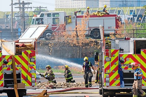 MIKE DEAL / WINNIPEG FREE PRESS
WFPS crews try to douse a large fire in the block on the southwest corner of Sutherland Avenue and Maple Street North Tuesday morning. 
230704 - Tuesday, July 4, 2023. 
