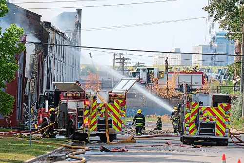 MIKE DEAL / WINNIPEG FREE PRESS
WFPS crews try to douse a large fire in the block on the southwest corner of Sutherland Avenue and Maple Street North Tuesday morning. 
230704 - Tuesday, July 4, 2023. 
