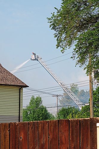 MIKE DEAL / WINNIPEG FREE PRESS
WFPS crews try to douse a large fire in the block on the southwest corner of Sutherland Avenue and Maple Street North Tuesday morning. 
230704 - Tuesday, July 4, 2023. 
