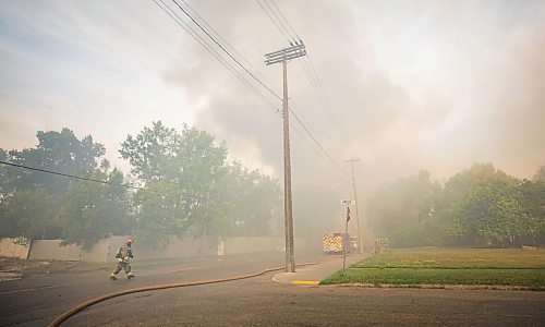 MIKE DEAL / WINNIPEG FREE PRESS
WFPS crews try to douse a large fire in the block on the southwest corner of Sutherland Avenue and Maple Street North Tuesday morning. 
230704 - Tuesday, July 04, 2023.