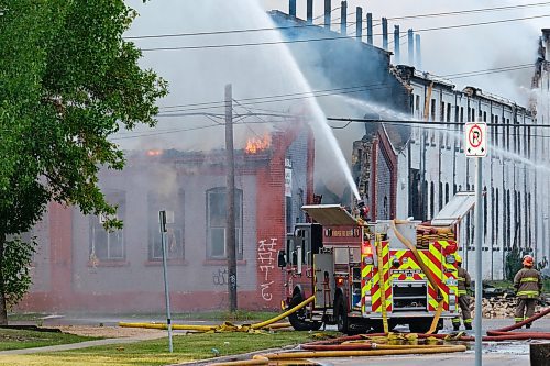 MIKE DEAL / WINNIPEG FREE PRESS
WFPS crews try to douse a large fire in the block on the southwest corner of Sutherland Avenue and Maple Street North Tuesday morning. 
230704 - Tuesday, July 04, 2023.