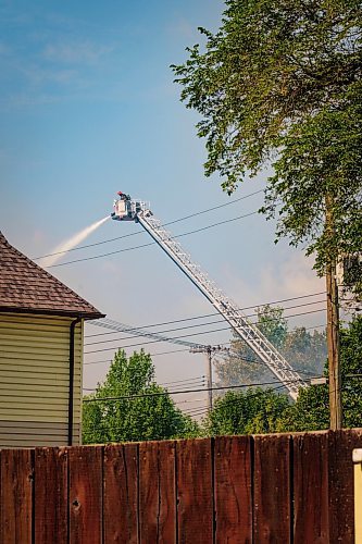 MIKE DEAL / WINNIPEG FREE PRESS
WFPS crews try to douse a large fire in the block on the southwest corner of Sutherland Avenue and Maple Street North Tuesday morning. 
230704 - Tuesday, July 04, 2023.