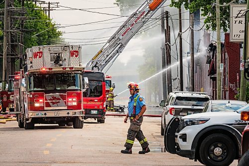 MIKE DEAL / WINNIPEG FREE PRESS
WFPS crews try to douse a large fire in the block on the southwest corner of Sutherland Avenue and Maple Street North Tuesday morning. 
230704 - Tuesday, July 04, 2023.