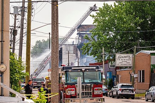 MIKE DEAL / WINNIPEG FREE PRESS
WFPS crews try to douse a large fire in the block on the southwest corner of Sutherland Avenue and Maple Street North Tuesday morning. 
230704 - Tuesday, July 04, 2023.