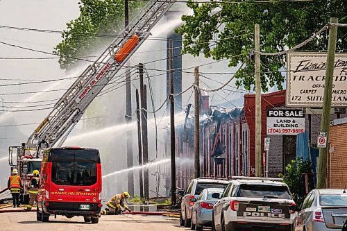 MIKE DEAL / WINNIPEG FREE PRESS
WFPS crews try to douse a large fire in the block on the southwest corner of Sutherland Avenue and Maple Street North Tuesday morning. 
230704 - Tuesday, July 04, 2023.