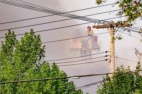 MIKE DEAL / WINNIPEG FREE PRESS
WFPS crews try to douse a large fire in the block on the southwest corner of Sutherland Avenue and Maple Street North Tuesday morning. 
230704 - Tuesday, July 04, 2023.