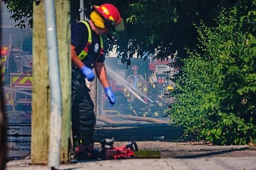 MIKE DEAL / WINNIPEG FREE PRESS
WFPS crews try to douse a large fire in the block on the southwest corner of Sutherland Avenue and Maple Street North Tuesday morning. 
230704 - Tuesday, July 04, 2023.