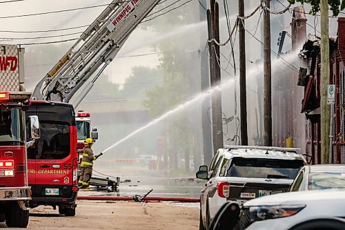 MIKE DEAL / WINNIPEG FREE PRESS
WFPS crews try to douse a large fire in the block on the southwest corner of Sutherland Avenue and Maple Street North Tuesday morning. 
230704 - Tuesday, July 04, 2023.