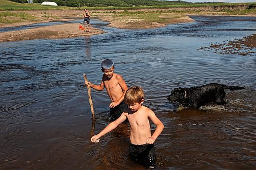 05072023
Cole Hartman and Octavius Egan explore the Little Saskatchewan River as Vanessa Egan watches from a sandbar on a warm and sunny Wednesday afternoon.  (Tim Smith/The Brandon Sun)