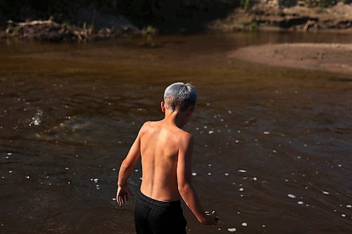 05072023
Cole Hartman, eight, wades in the Little Saskatchewan River with friends during an afternoon exploring the river west of Brandon on Wednesday.  (Tim Smith/The Brandon Sun)