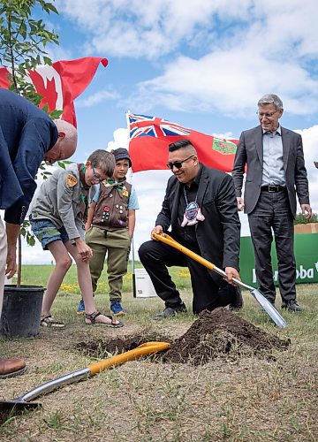 Mike Thiessen / Winnipeg Free Press 
Councillor Deon Clarke (centre) and two members of the 1st Crestview Scout Group planting a sapling at FortWhyte Alive. The province announced Manitoba&#x2019;s 2 Billion Trees program, with $8.85M contributions from both the federal and provincial governments. For Graham McDonald. 230705 &#x2013; Wednesday, July 5, 2023