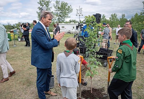 Mike Thiessen / Winnipeg Free Press 
Environment and Climate Minister Kevin Klein (left) informing two members of the 1st Crestview Scout Group how many more trees they need to plant before they reach two billion. The province announced Manitoba&#x2019;s 2 Billion Trees program, with $8.85M contributions from both the federal and provincial governments. For Graham McDonald. 230705 &#x2013; Wednesday, July 5, 2023