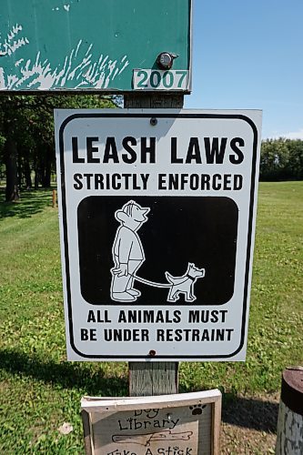A sign posted at the Neepawa Bird Sanctuary states that all animals must be kept on a leash at all times while at the park and sanctuary grounds. Two dogs unleashed a vicious attack after digging under fencing at the sanctuary and killing 14 birds and one rabbit. The whereabouts of two kittens are unknown. (Miranda Leybourne/The Brandon Sun)