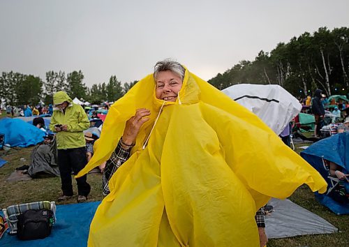 JESSICA LEE / WINNIPEG FREE PRESS

Donna Conroy attempts to stay dry July 6, 2023 at Folk Fest during a downpour.

Reporter: Eva Wasney