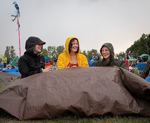 JESSICA LEE / WINNIPEG FREE PRESS

From left to right: Mira Wirzba, Michelle Fast and Annie Hollander attempt to stay dry July 6, 2023 at Folk Fest during a downpour.

Reporter: Eva Wasney