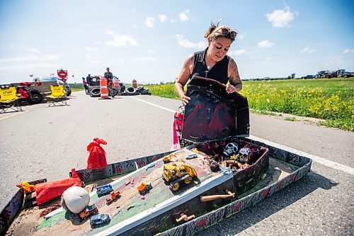 MIKAELA MACKENZIE / WINNIPEG FREE PRESS

Melissa Robinson shows a model of the landfill, filled with bodies and body parts, at the blockade/camp after the province announced that they will not be funding a landfill search for the murdered women on Thursday, July 6, 2023.  For Chris Kitching story.
Winnipeg Free Press 2023.