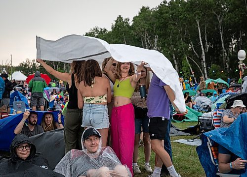 JESSICA LEE / WINNIPEG FREE PRESS

Festival attendees attempt to stay dry July 6, 2023 at Folk Fest during a downpour.

Reporter: Eva Wasney