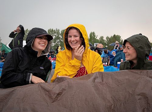 JESSICA LEE / WINNIPEG FREE PRESS

From left to right: Mira Wirzba, Michelle Fast and Annie Hollander attempt to stay dry July 6, 2023 at Folk Fest during a downpour.

Reporter: Eva Wasney