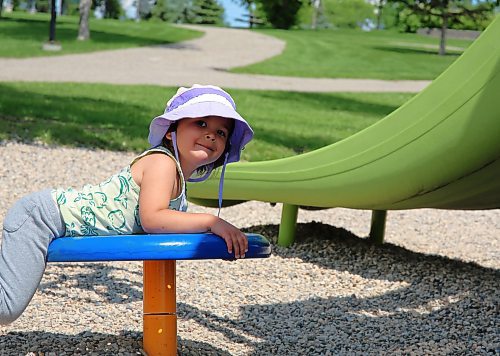 Three-year-old Juno Dunn wears a protective hat while enjoying the playground at Rideau Park in Brandon on Friday. (Michele McDougall/The Brandon Sun)