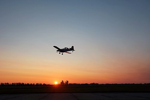 07072023
John Lepp with Rivers Air Spray passes over the former CFB Rivers base near Wheatland, Manitoba at the start of a busy day of aerial fungicide application at sunrise on Friday. 
(Tim Smith/The Brandon Sun)