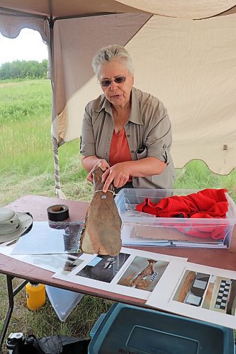 Dr. Mary Malainey of Brandon University showcases a farming hoe made from bison scapula at the beginning of Saturday's tour of the school's archaeological excavation site located south of Melita. The discovery if these bison-bone hoes from 2018, by nature lover Eric Olson, kicked off a giant archaeological dig in the region that's lead to the discovery of countless other artefacts that point to pre-contact Indigenous life in the region. (Kyle Darbyson/The Brandon Sun)