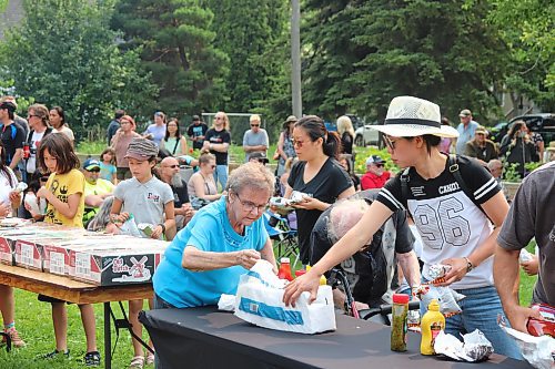 Local families gather at the Park Community Centre Sunday afternoon to indulge in some free barbecue. (Kyle Darbyson/The Brandon Sun)