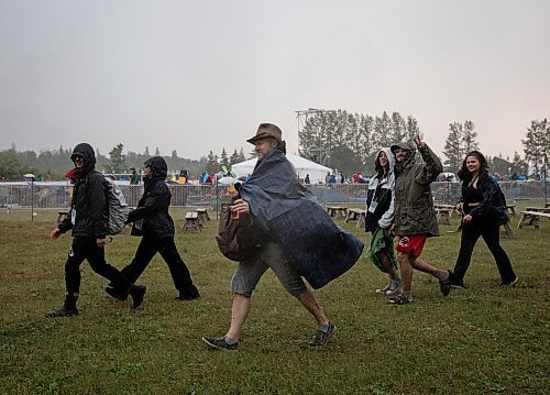 JESSICA LEE / WINNIPEG FREE PRESS

Festival attendees escape the rain July 6, 2023 at Folk Fest during a downpour.

Reporter: Eva Wasney