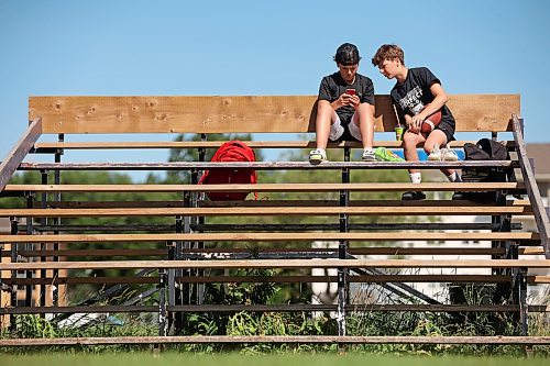 10072023
Twin brothers Kaleb and Gabriel McAuley visit on a set of bleachers while waiting for Vikings football summer camp at Vincent Massey High School in Brandon on a warm Monday afternoon.
(Tim Smith/The Brandon Sun)