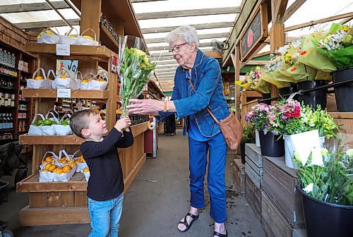 RUTH BONNEVILLE / WINNIPEG FREE PRESS

Standup - Shopping with Great-grandma

Three-year-old Dax Kuffel, checks out various bouquets of flowers with his great-grandmother, Henriette Labossiere, while out with his family on their weekly shopping trip together with his great-grandmother  at St-L&#xe9;on Market Gardens Wednesday.

July 12th,  2023
