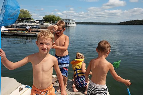 12072023
Axel Doerksen, Slater Doerksen, Avaya Hyatt and Gibson Doerksen try to catch minnows and other lake creatures while dipnetting at the Clear Lake Marina on Wednesday.  (Tim Smith/The Brandon Sun)