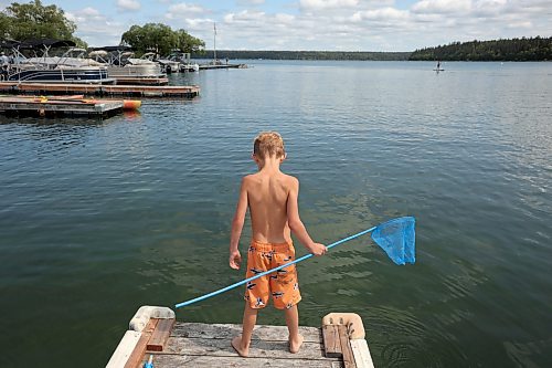 12072023
Axel Doerksen scans the water for creatures to catch while dipnetting with family at the Clear Lake Marina on Wednesday.  (Tim Smith/The Brandon Sun)