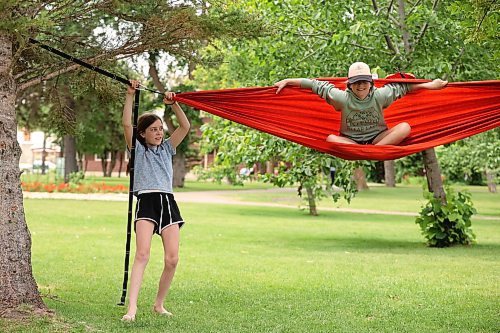 12072023
Sisters (names withheld) play with a hammock while enjoying at Clear Lake in Wasagaming on Wednesday.  (Tim Smith/The Brandon Sun)