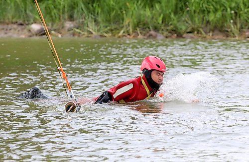 A student with the Manitoba Emergency Services College hops over an artificial &quot;log&quot; on the surface of the Assiniboine River near the walking bridge at the Riverbank Discovery Centre trails. The obstruction is meant to test a student's ability to get past obstacles during water rescue missions. Ten students and their evaluators took part in the all-day excercises between Dinsdale Park and the bridge on Wednesday. These exercises will continue in Brandon and Rivers until July 19. (Matt Goerzen/The Brandon Sun)