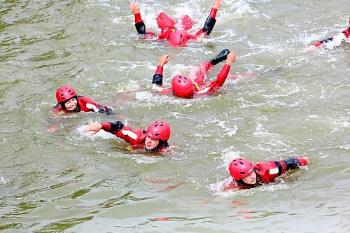 Students with the Manitoba Emergency Services College swim across the Assiniboine River as part of course-end life-saving training exercises near the walking bridge at the Riverbank Discovery Centre trails. Ten students and their evaluators took part in the all-day excercises between Dinsdale Park and the bridge on Wednesday. These exercises will continue in Brandon and Rivers until July 19. (Matt Goerzen/The Brandon Sun)