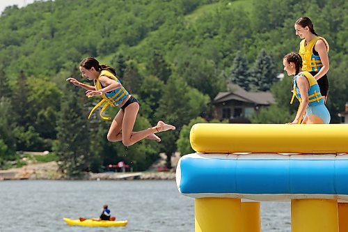 Eastyn Beach, 12, leaps off a tower while playing with family at the Splish Splash Water Park at Minnedosa Lake on a sunny Thursday. See more photos on Page A3. (Tim Smith/The Brandon Sun)