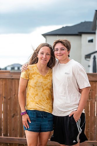 MIKAELA MACKENZIE / WINNIPEG FREE PRESS

Jill Chapman and her son, Adam Donaghy, at their home on Thursday, July 13, 2023. Adam Donaghy is a transgender high schooler who has been on the waiting list for HSC&#x2019;s Gender Dysphoria Assessment and Action for Youth Centre (GDAAY) program for nearly three years.  For Eva/Katie story.
Winnipeg Free Press 2023.