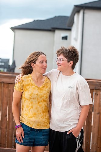 MIKAELA MACKENZIE / WINNIPEG FREE PRESS

Jill Chapman and her son, Adam Donaghy, at their home on Thursday, July 13, 2023. Adam Donaghy is a transgender high schooler who has been on the waiting list for HSC&#x2019;s Gender Dysphoria Assessment and Action for Youth Centre (GDAAY) program for nearly three years.  For Eva/Katie story.
Winnipeg Free Press 2023.